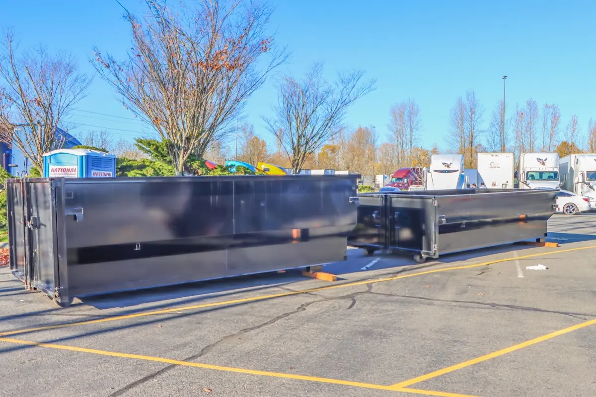 Professional dumpster rental service with roll-off container on residential driveway in Grafton